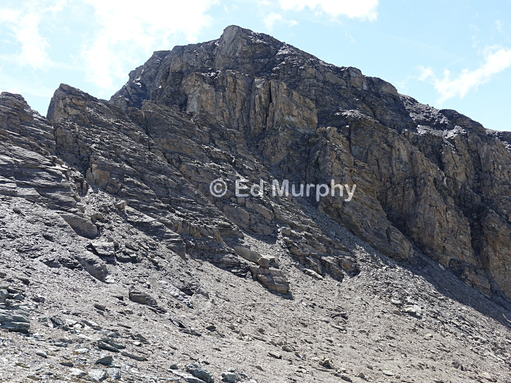 The light stone slab in the shade marks the entrance to a hidden couloir