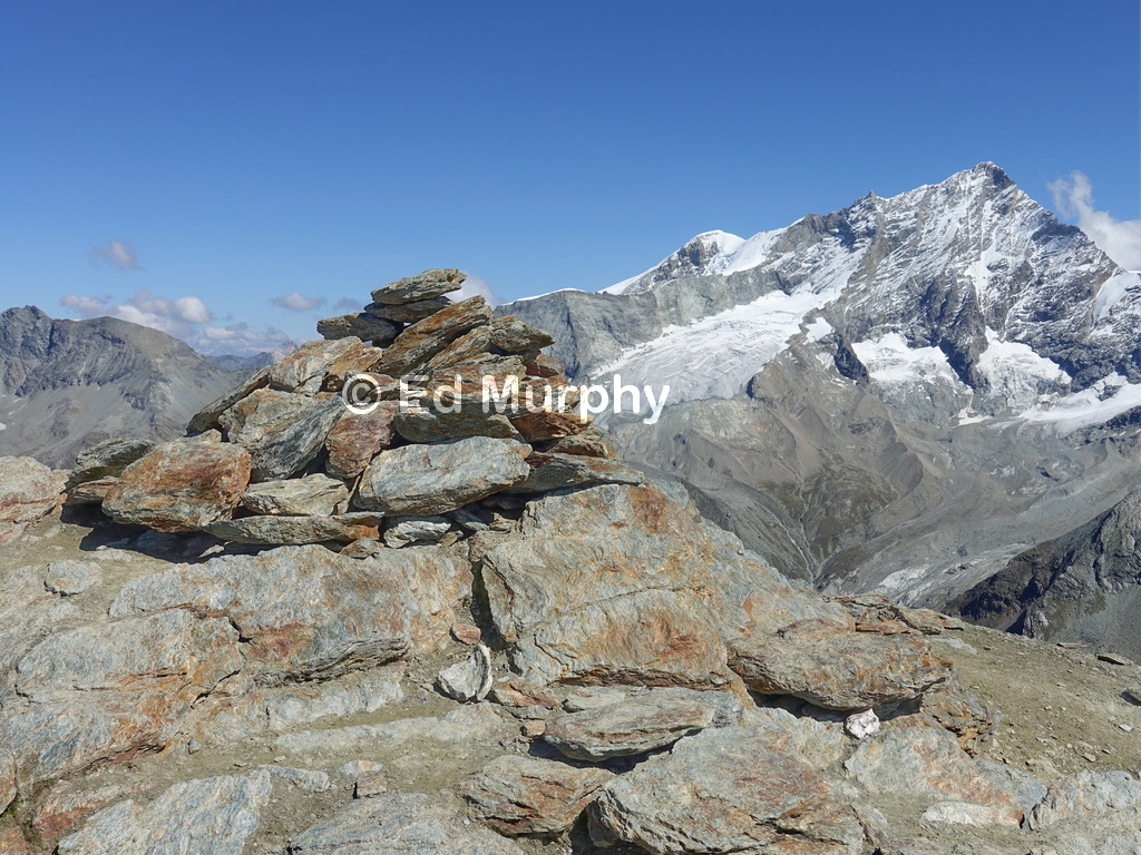 The Pigne de la L&eacute;'s summit cairn and the Weisshorn